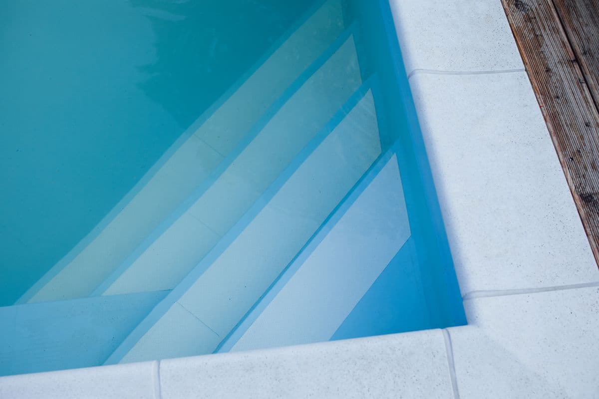 Cold plunge recovery pool with tiled steps at the AMP Fitness gym amenities in Mesa, AZ.