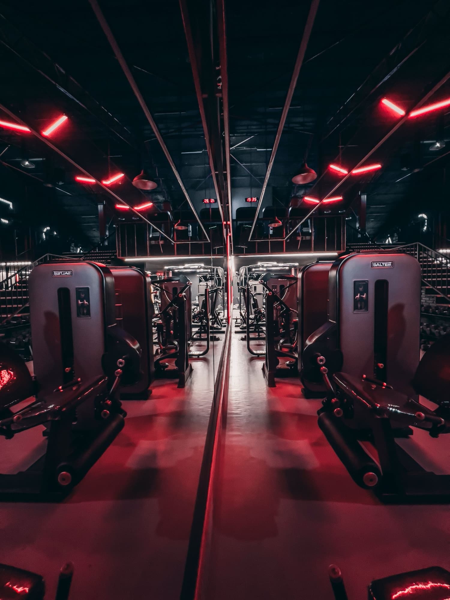 Training floor lit in red, representing red light therapy in the AMP Fitness gym amenities in Mesa, AZ.