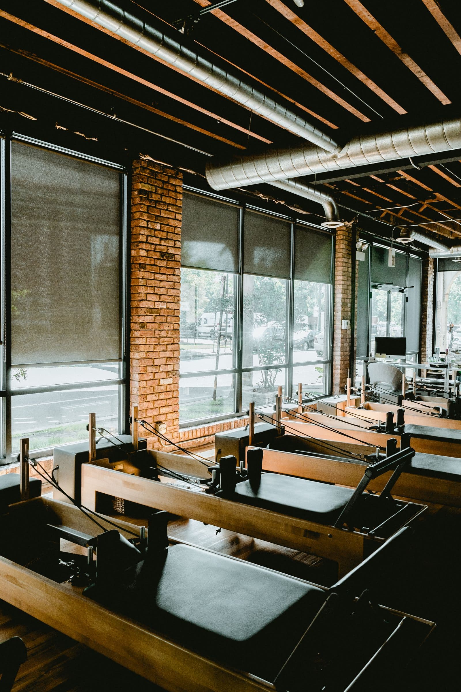 Reformer Pilates studio with spring-loaded machines at AMP Fitness in Mesa, AZ.