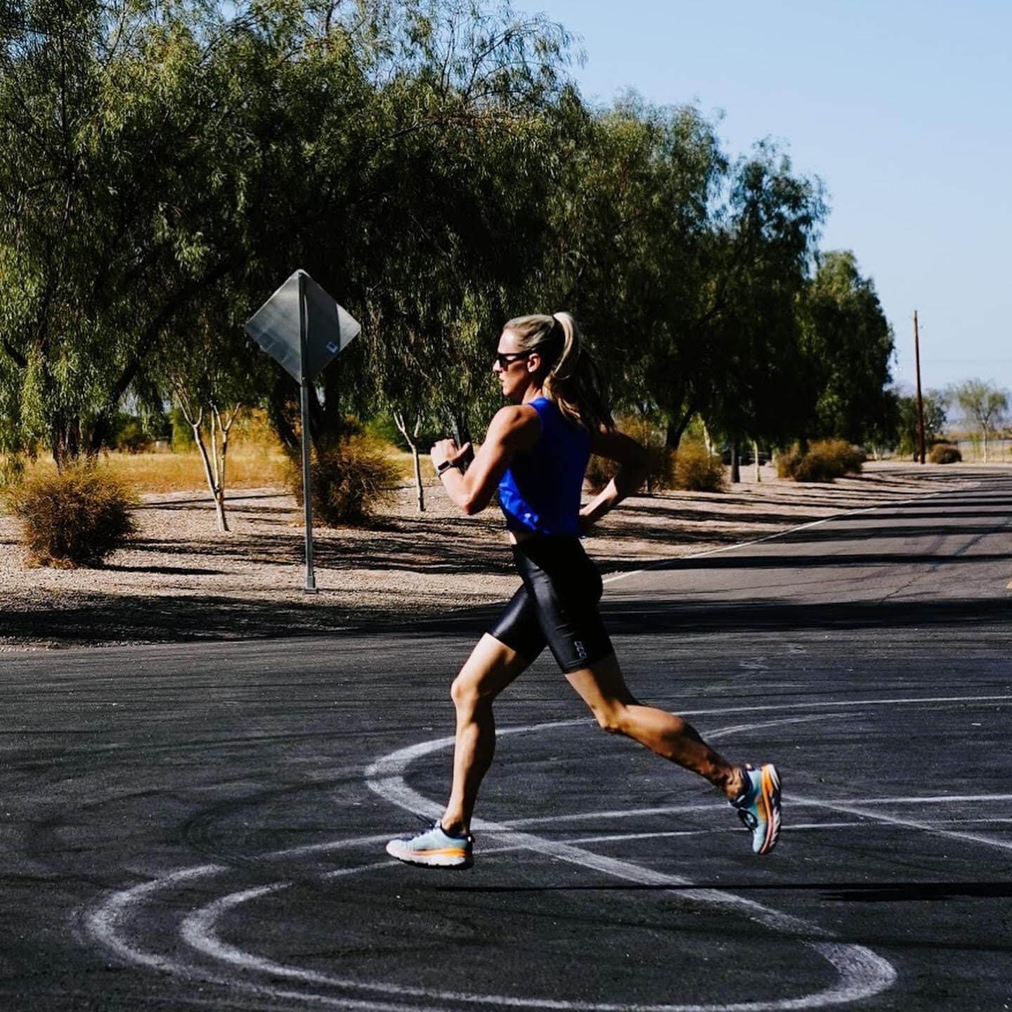 Runner training on a desert road near Mesa, AZ with AMP Fitness run coaching.
