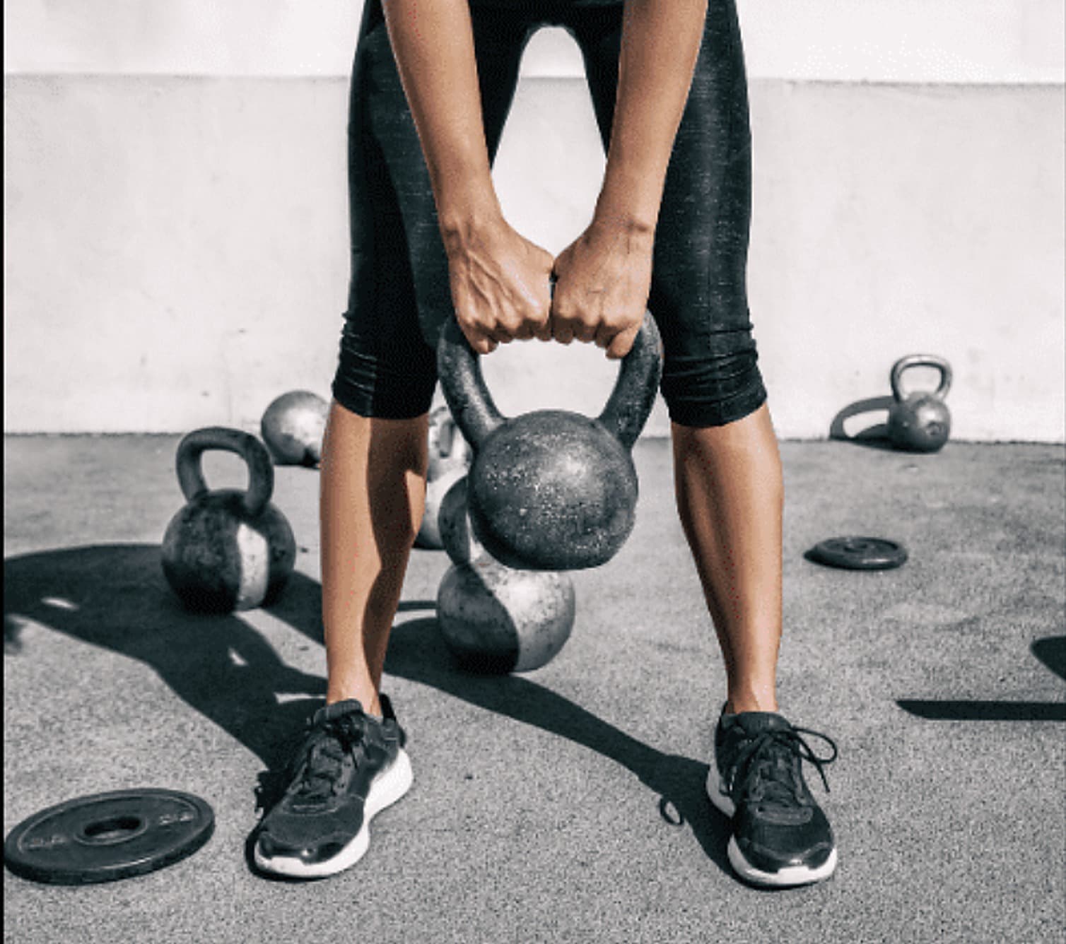 Kettlebell workout with weights on the floor, representing AMP Fitness on-demand video workouts you can stream from Mesa, AZ.